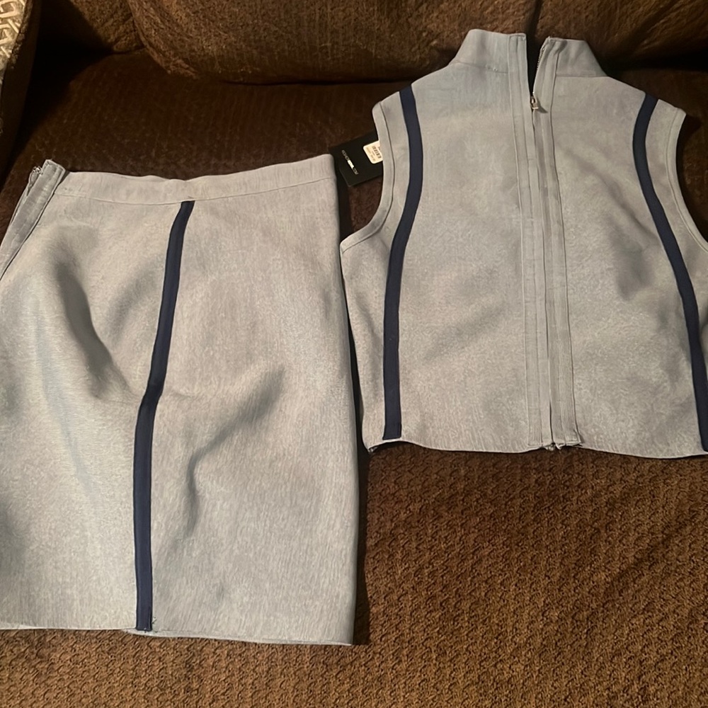 two piece denim skirt set that zips up in the front and has a cute shiny zipper